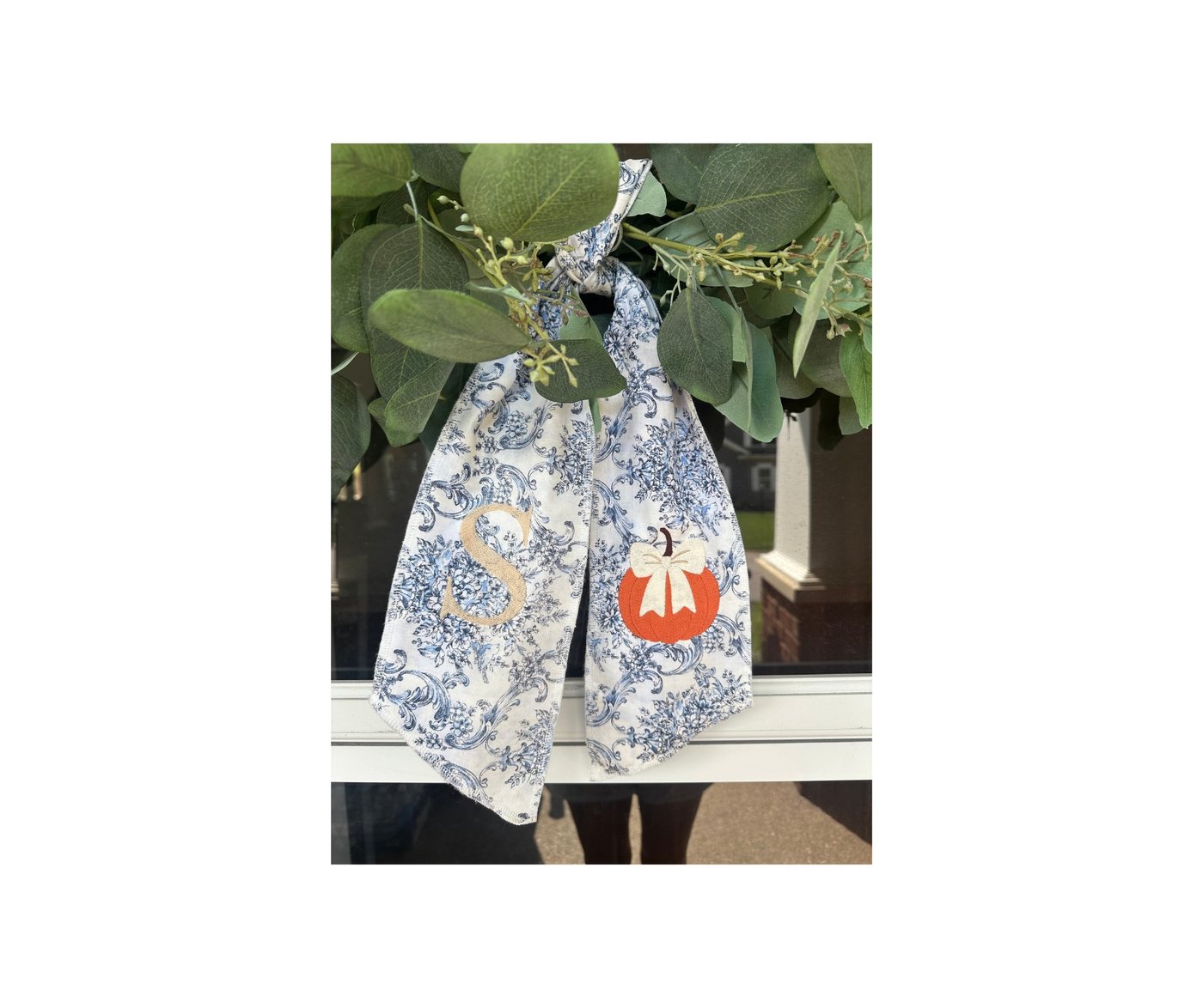 Blue toile wreath sash with monogram and orange pumpkin applique